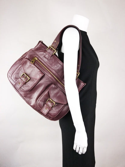 Marc Jacobs Stella Tote Bag With Front Buckle And Zipper Pockets In Burgundy Leather With Bronze Tone Hardware